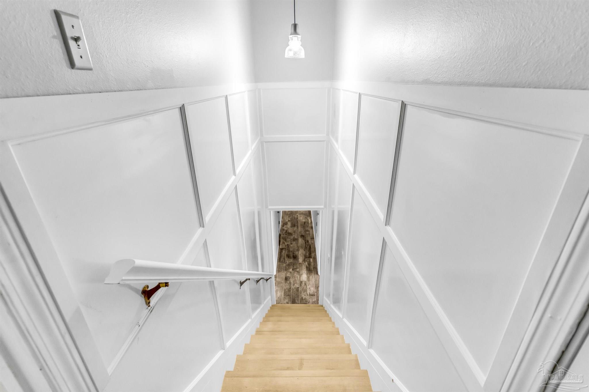 6912 Kitty Hawk Drive Pensacola, FL 32506 - Photo 40 of 61 a view of entryway with stairs and wooden floor