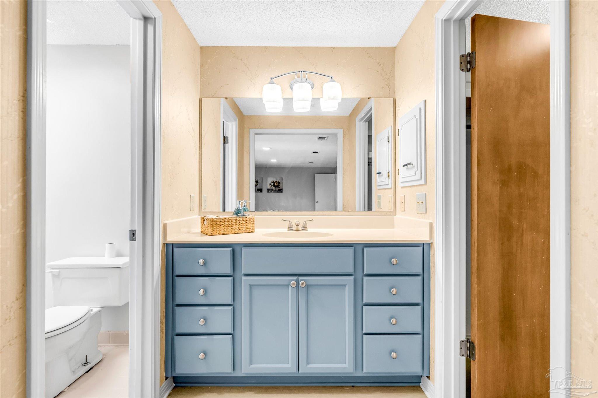 6912 Kitty Hawk Drive Pensacola, FL 32506 - Photo 43 of 61 a bathroom with a double vanity sink and a mirror
