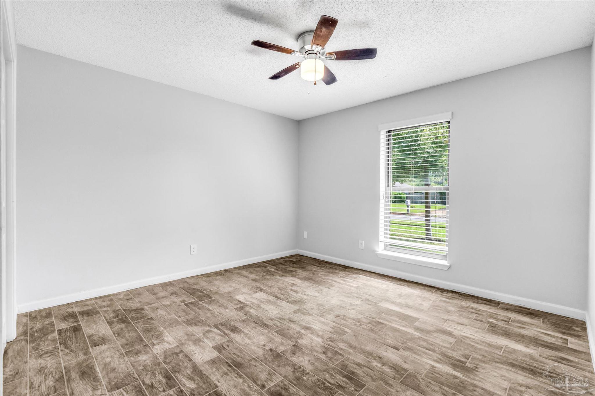 6912 Kitty Hawk Drive Pensacola, FL 32506 - Photo 48 of 61 an empty room with a window and a fan