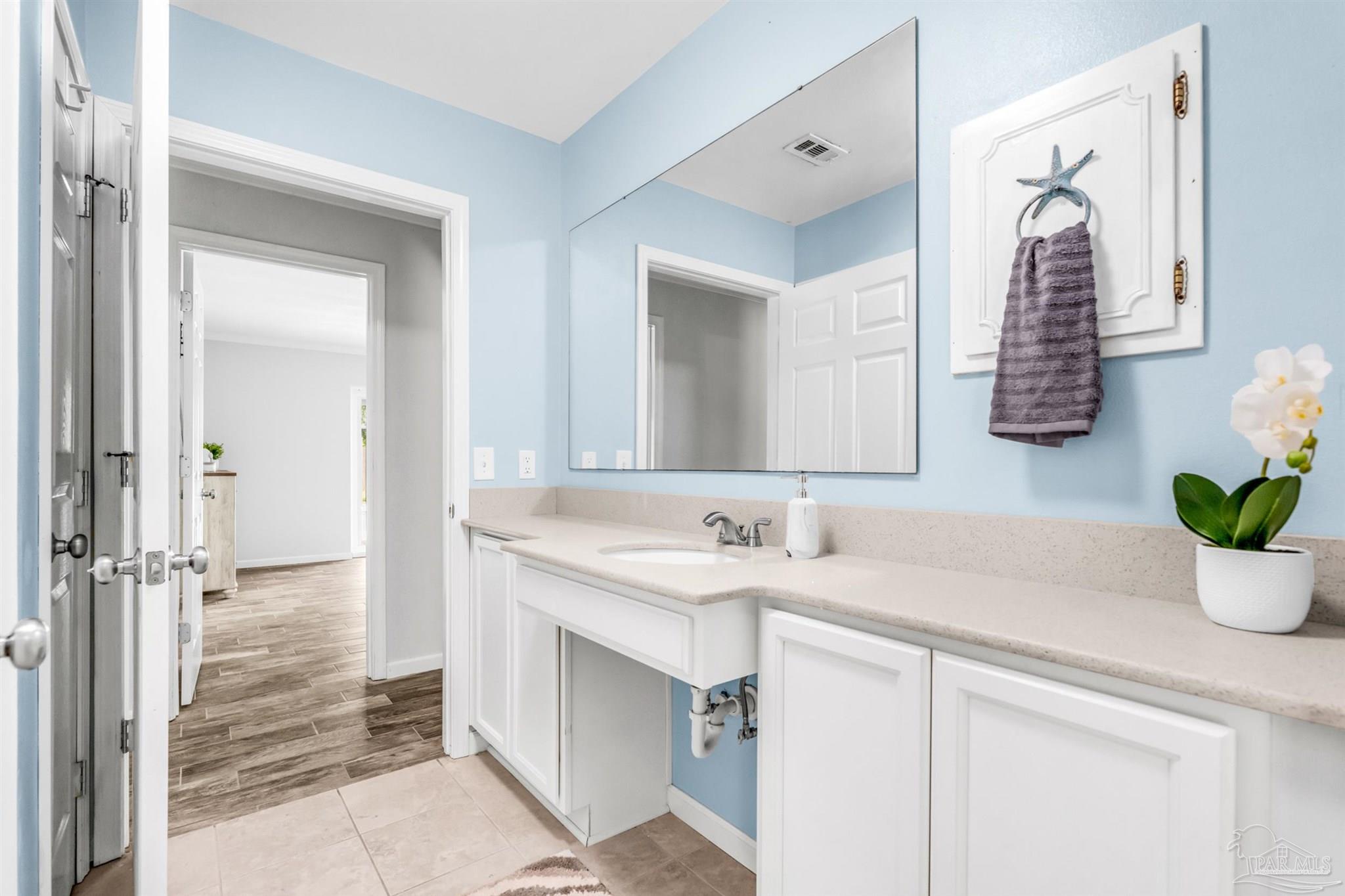 6912 Kitty Hawk Drive Pensacola, FL 32506 - Photo 49 of 61 a bathroom with a sink and a mirror