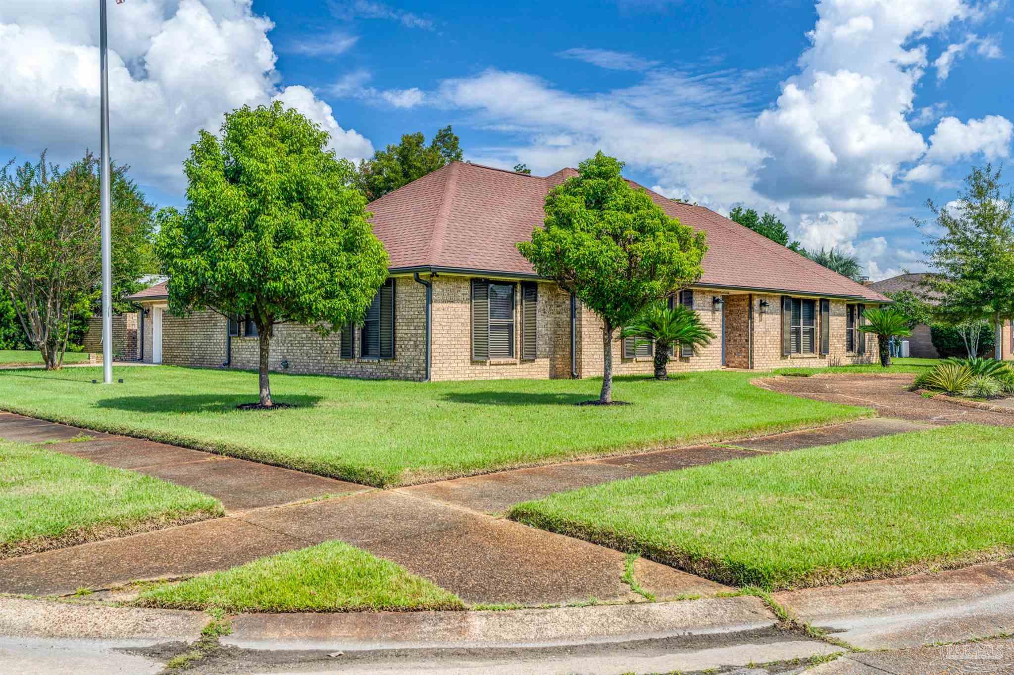6912 Kitty Hawk Drive Pensacola, FL 32506 - Photo 5 of 61 front view of a house with a yard