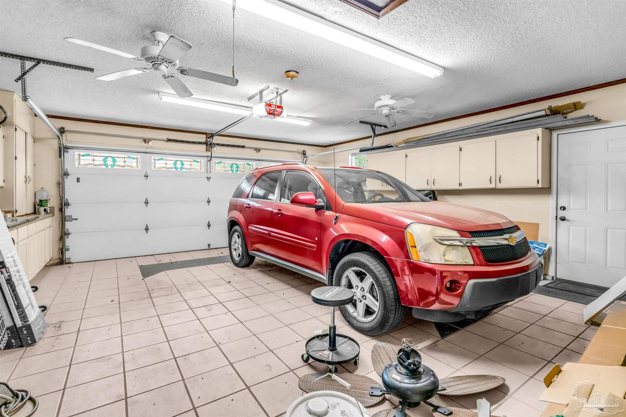 6912 Kitty Hawk Drive Pensacola, FL 32506 - Photo 56 of 61 a car is parked in a garage