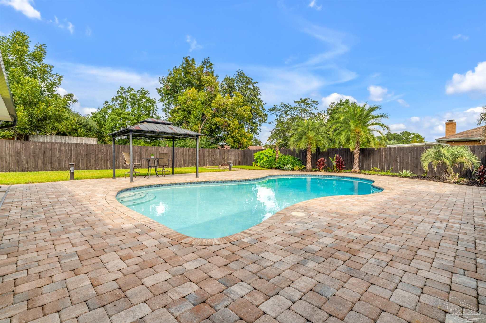 6912 Kitty Hawk Drive Pensacola, FL 32506 - Photo 7 of 61 a view of a swimming pool with a yard