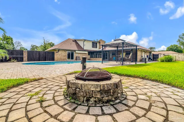 a view of a house with backyard porch and sitting area
