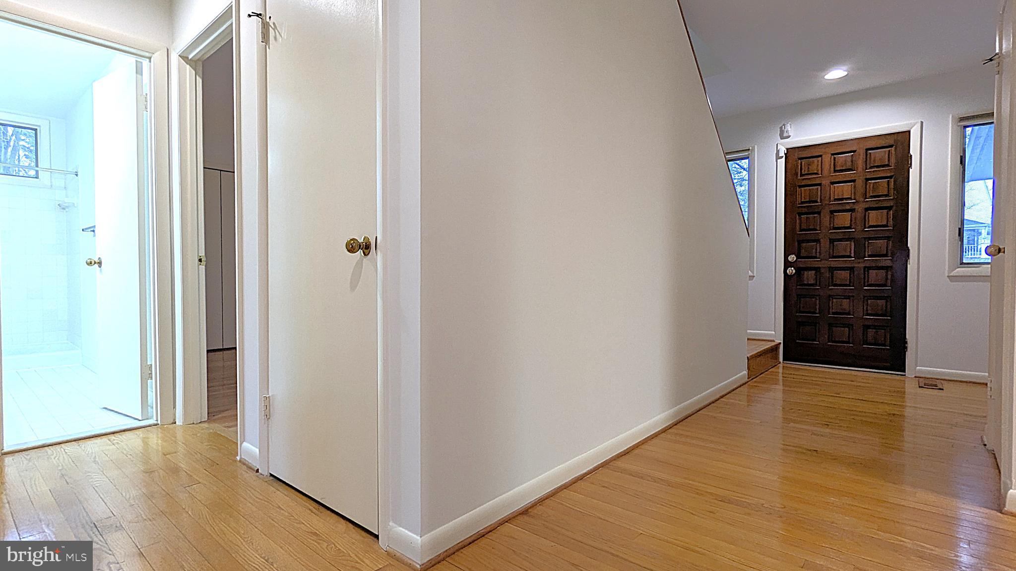 11589 Lake Newport Road Reston, VA 20194 - Photo 33 of 66 a view of an empty room with wooden floor and a window