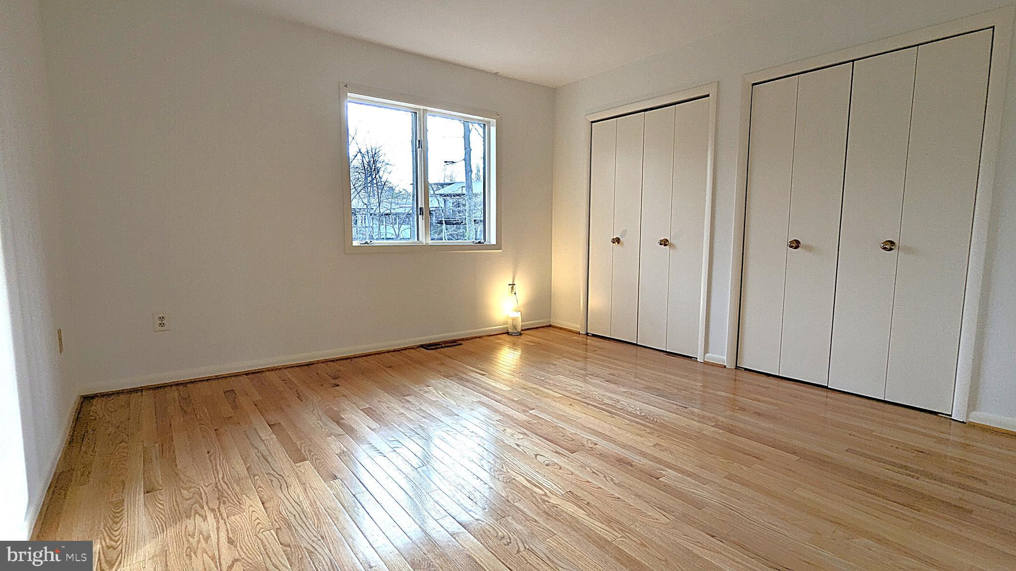11589 Lake Newport Road Reston, VA 20194 - Photo 38 of 66 a view of an empty room with wooden floor and a window