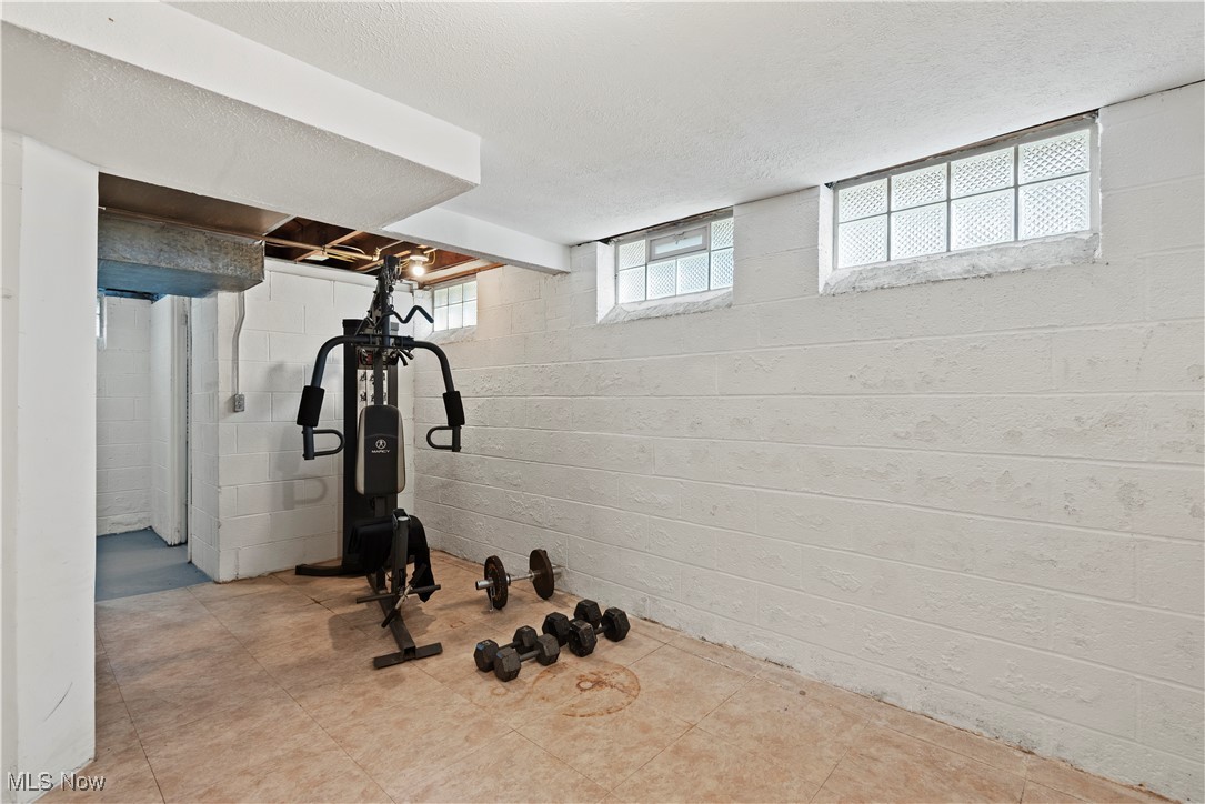 1271 Lander Road Cleveland, OH 44124 - Photo 26 of 37 The Lower level is partially finished and ready to serve your active lifestyle or when it's time to relax. This room shown with workout equipment.