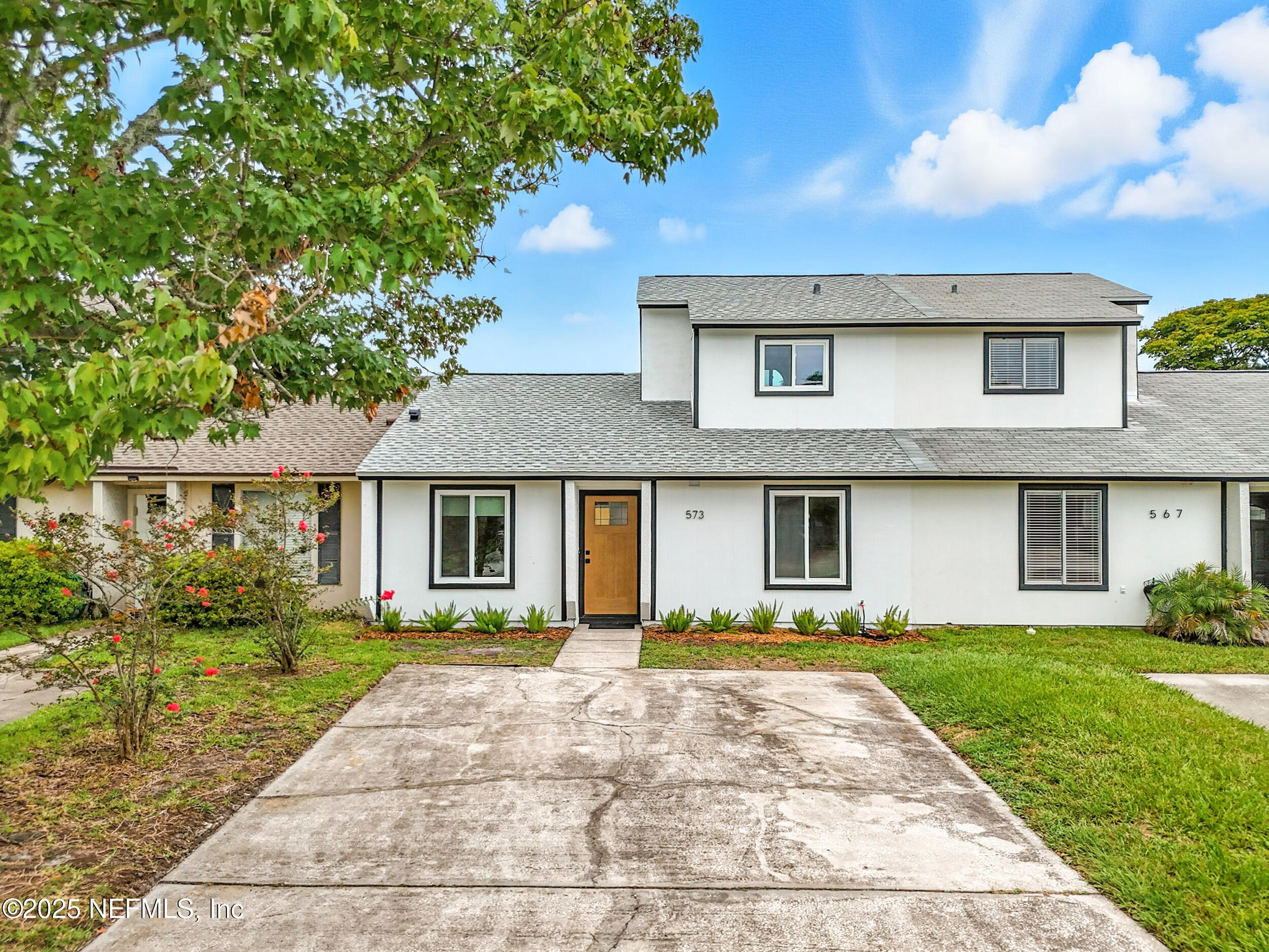 a front view of a house with a garden