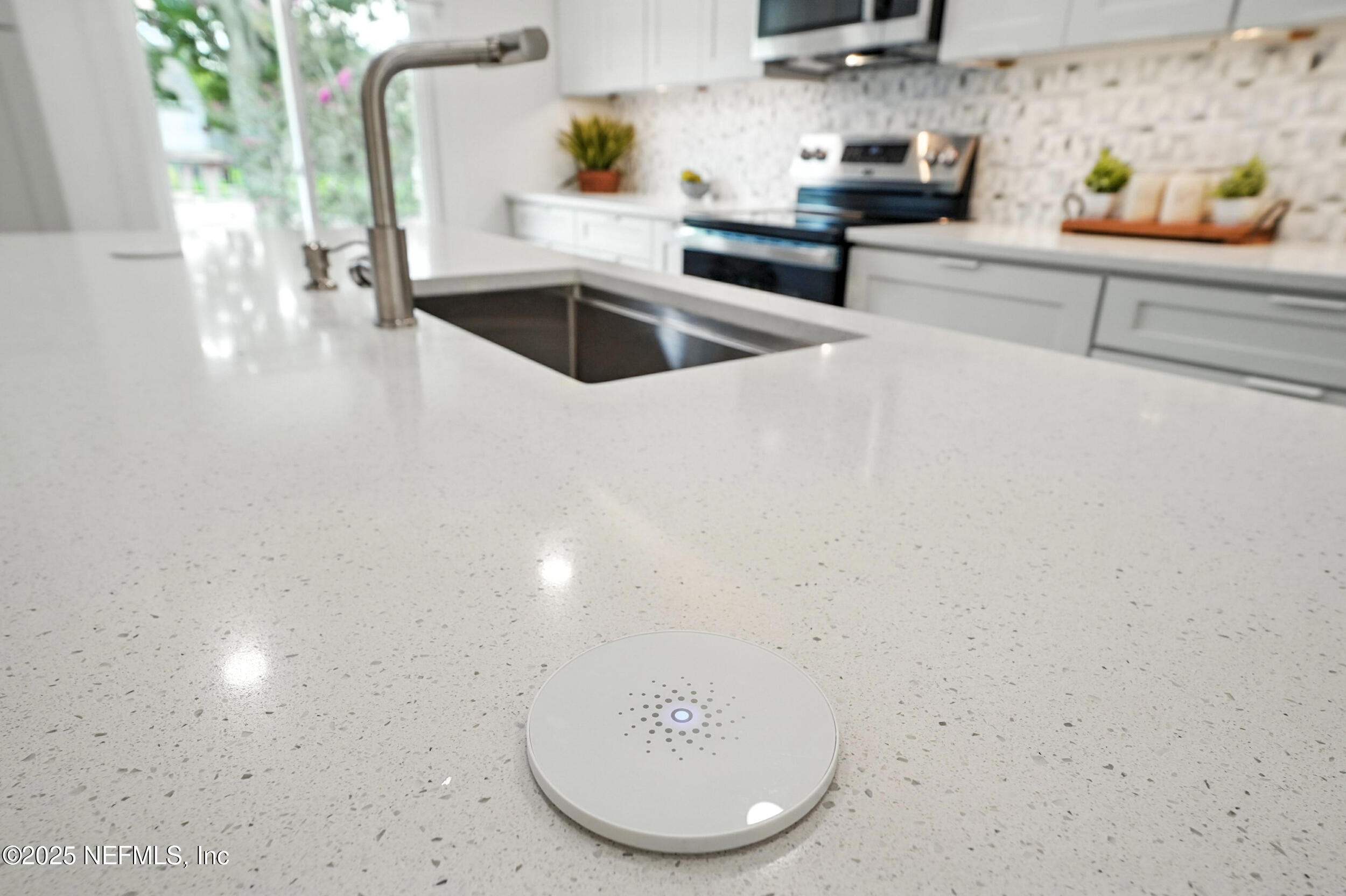 573 Aquatic Drive Atlantic Beach, FL 32233 - Photo 11 of 26 a kitchen with stainless steel appliances a sink a stove and cabinets