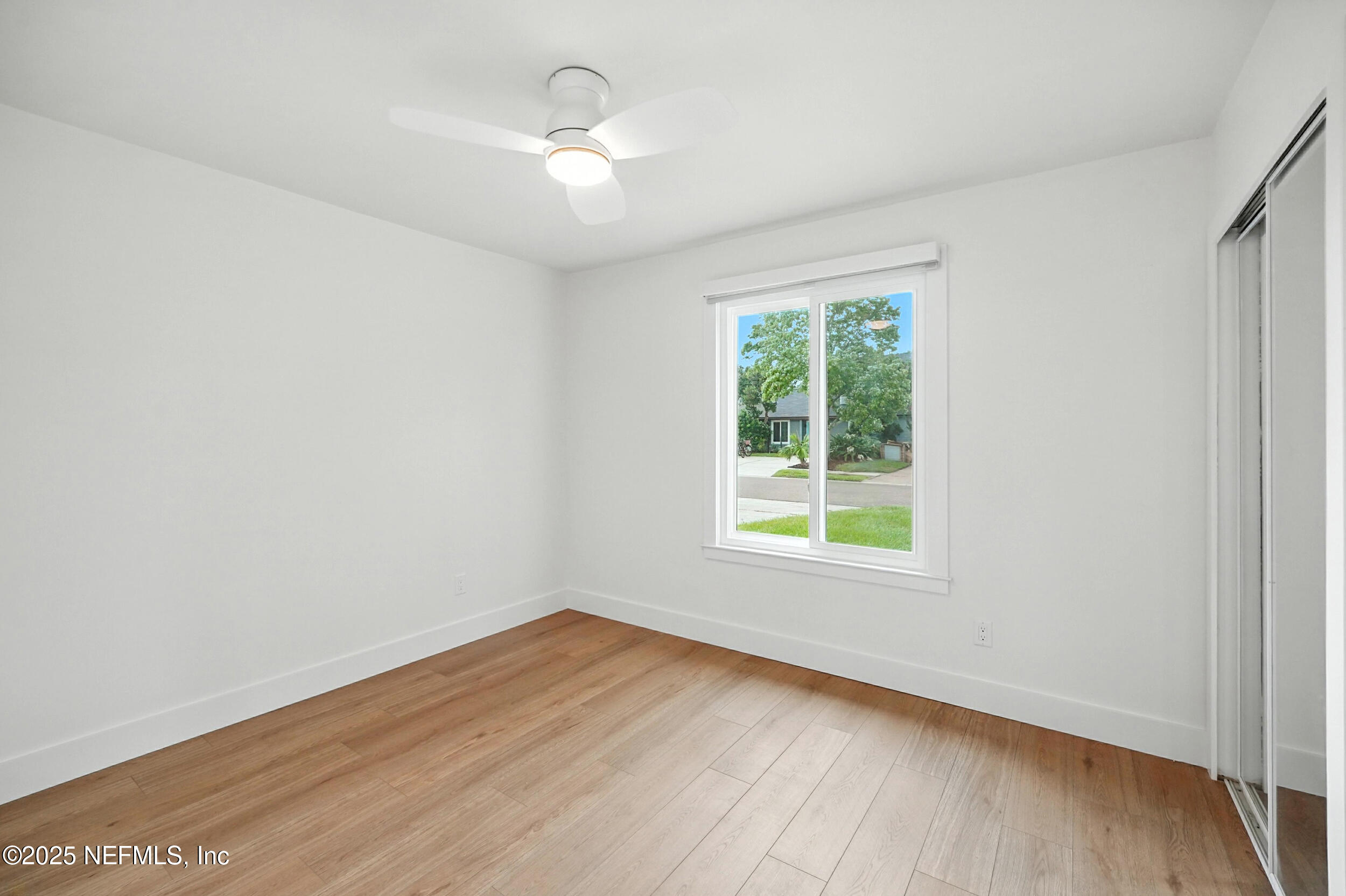 573 Aquatic Drive Atlantic Beach, FL 32233 - Photo 12 of 26 an empty room with wooden floor and windows
