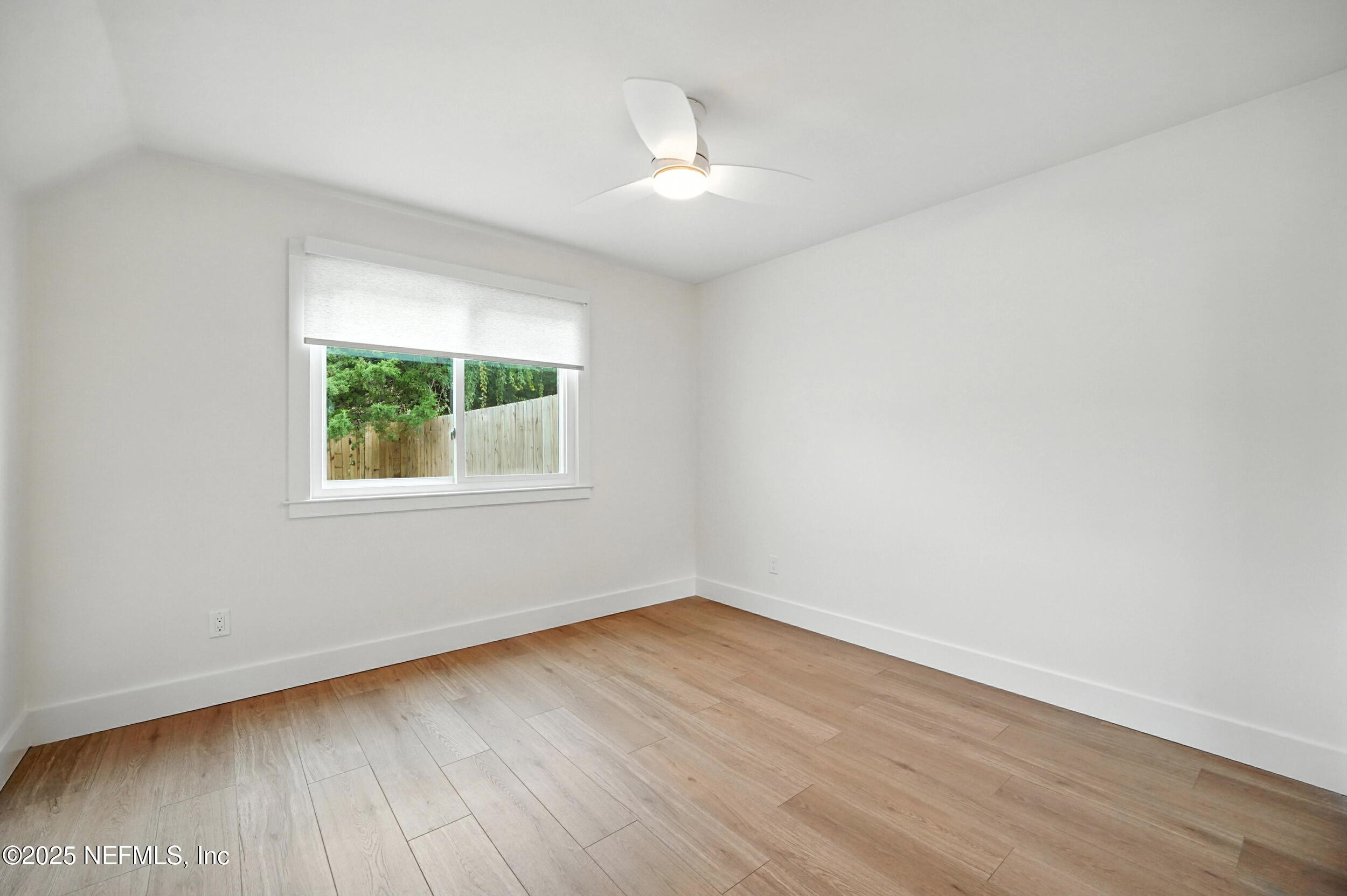 573 Aquatic Drive Atlantic Beach, FL 32233 - Photo 13 of 26 an empty room with wooden floor and windows