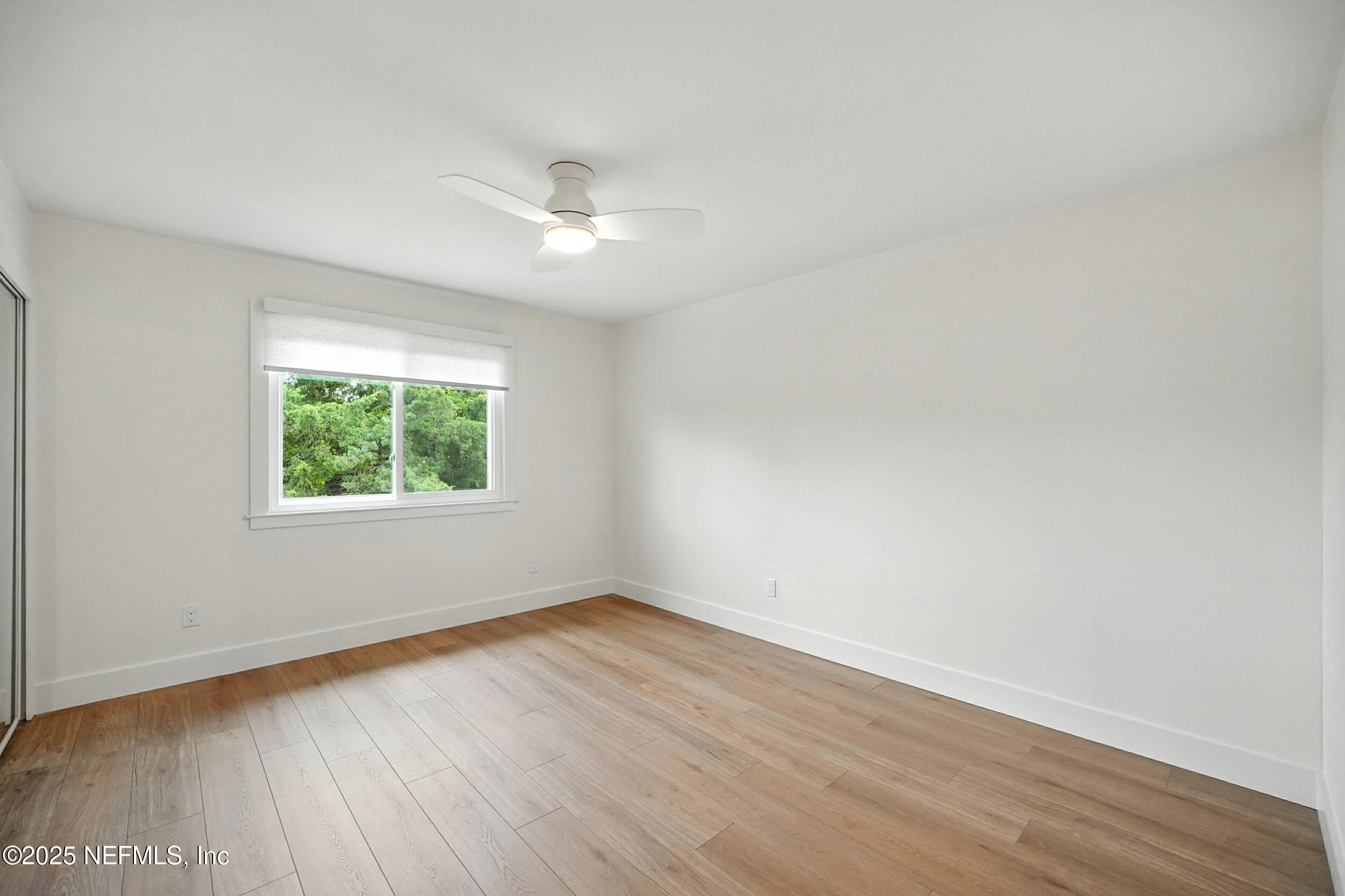 573 Aquatic Drive Atlantic Beach, FL 32233 - Photo 16 of 26 an empty room with wooden floor and windows