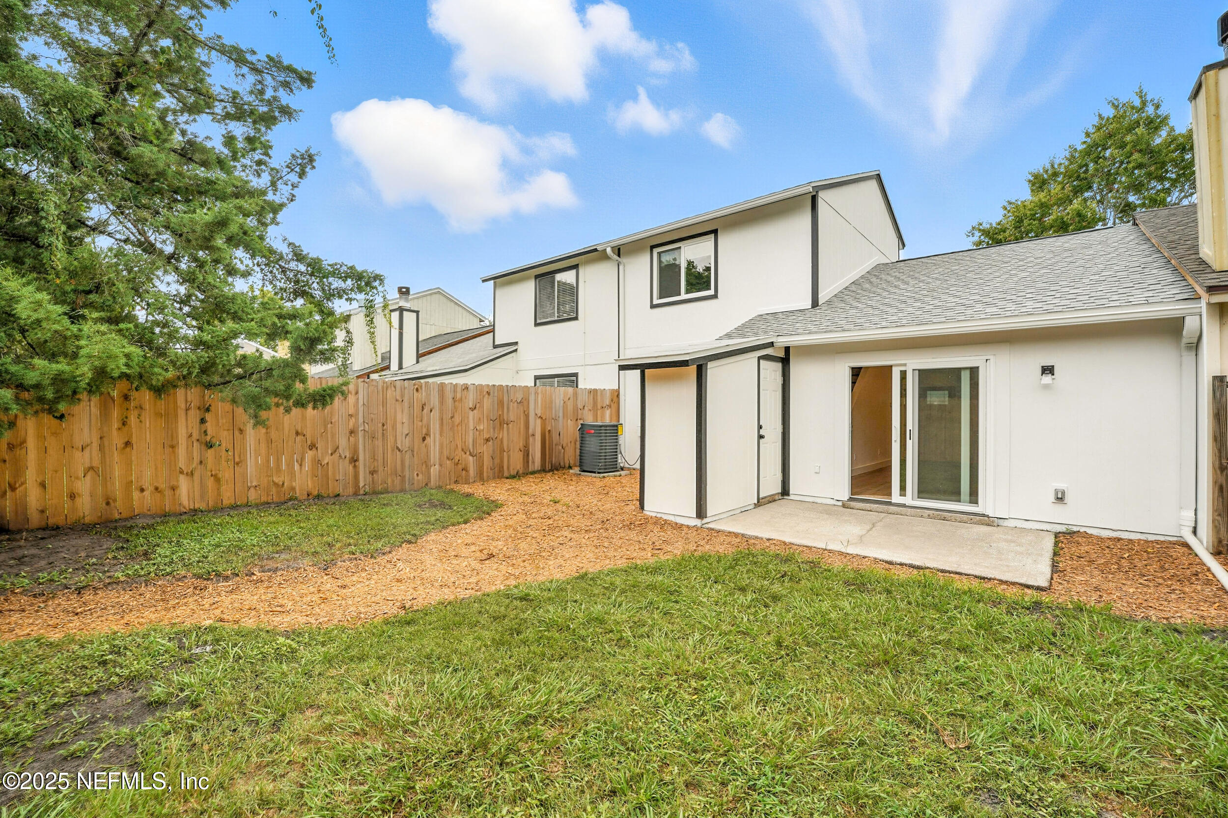 573 Aquatic Drive Atlantic Beach, FL 32233 - Photo 24 of 26 a view of a house with a yard and tree