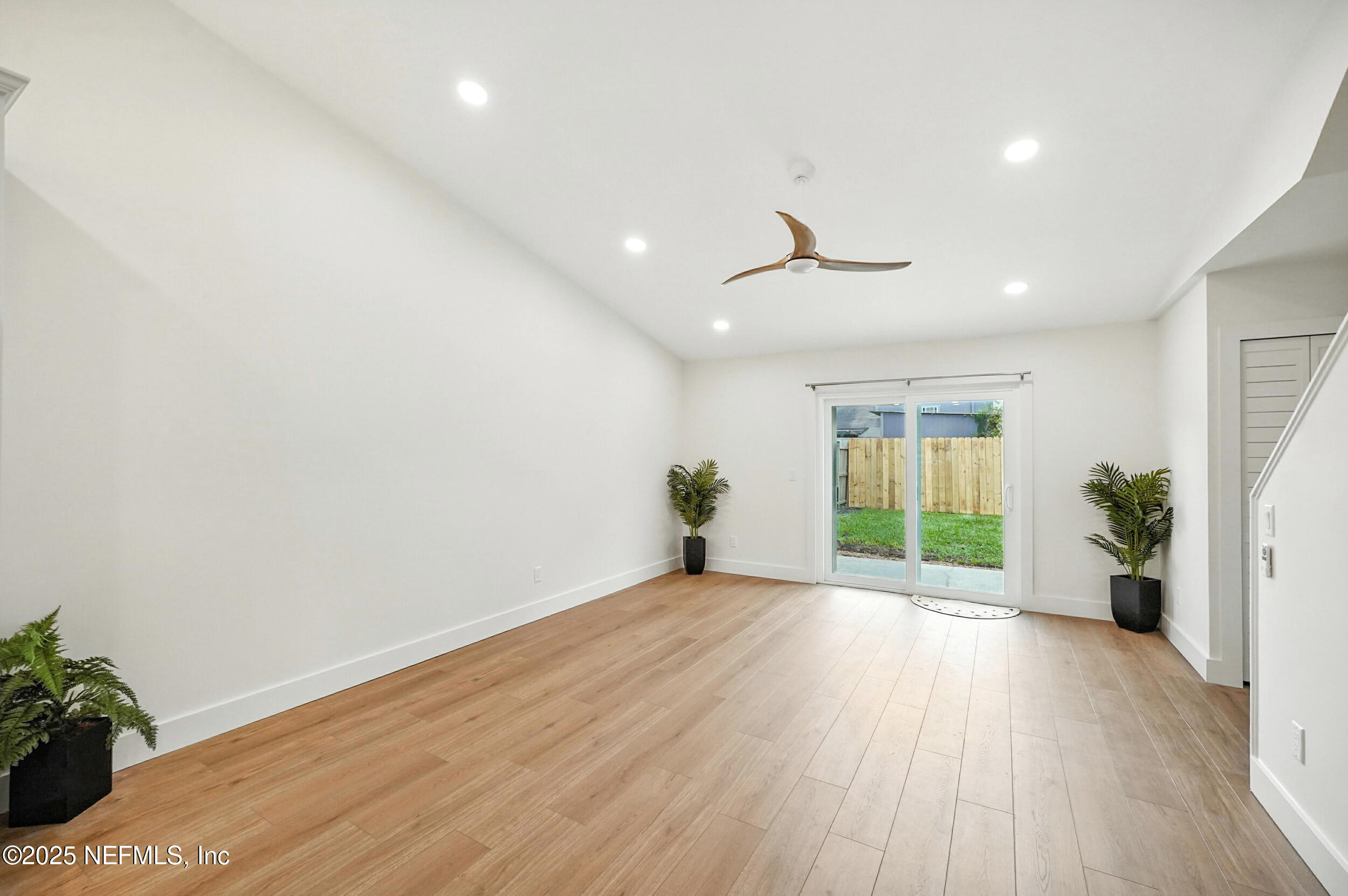 573 Aquatic Drive Atlantic Beach, FL 32233 - Photo 5 of 26 a view of an empty room with a window and wooden floor
