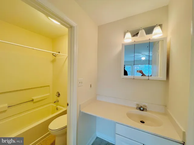 a bathroom with a tub and sink