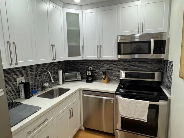 a kitchen with granite countertop a stove and a sink