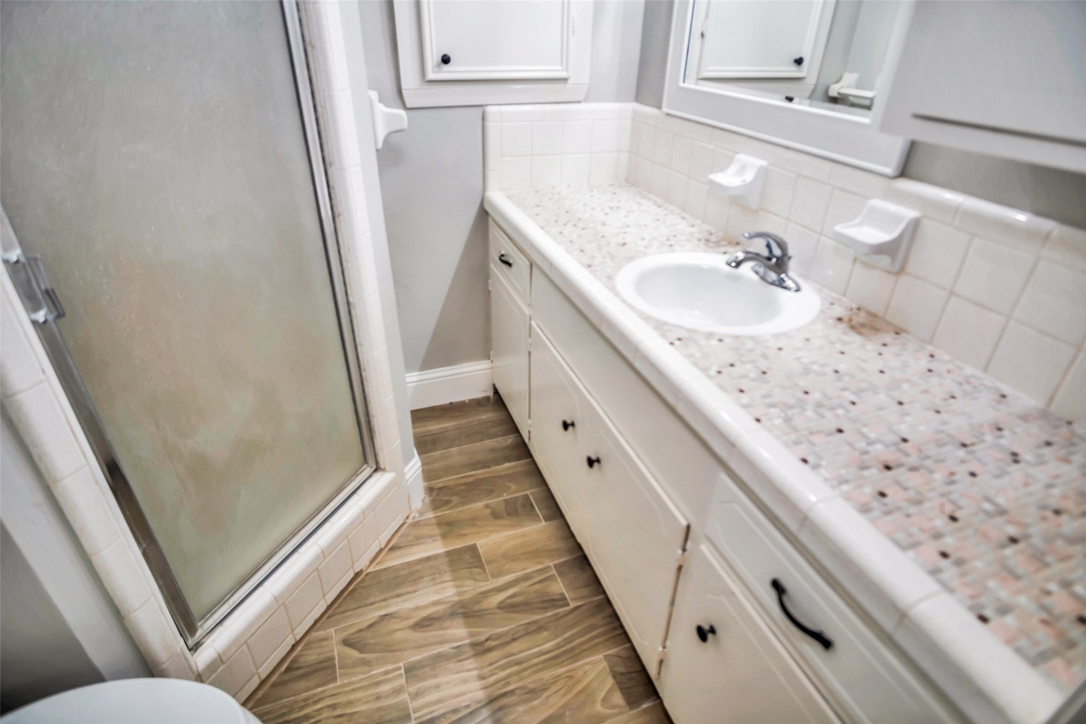 1715 Capstan Road Houston, TX 77062 - Photo 17 of 40 a bathroom with a sink a toilet and shower