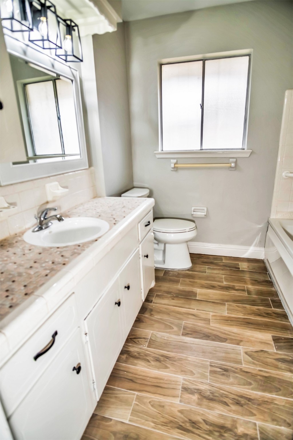 1715 Capstan Road Houston, TX 77062 - Photo 20 of 40 a bathroom with a sink a toilet and a window