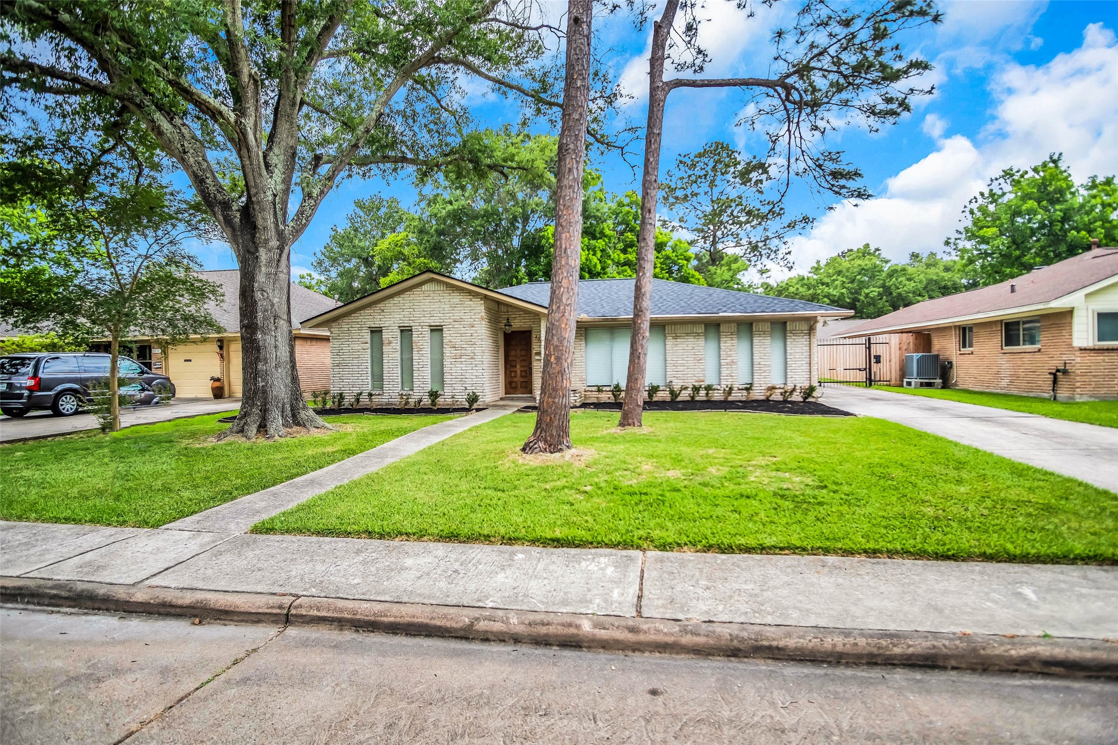 1715 Capstan Road Houston, TX 77062 - Photo 2 of 40 a front view of a house with a garden and trees