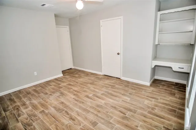 a view of a room with wooden floor