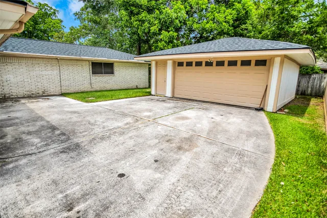 a view of a house with a yard and fence