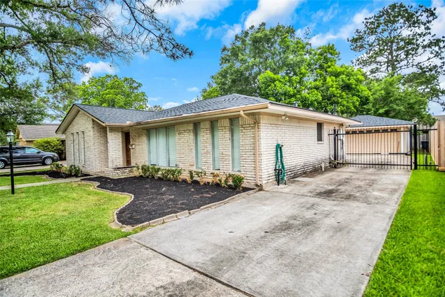 a front view of a house with yard patio and green space