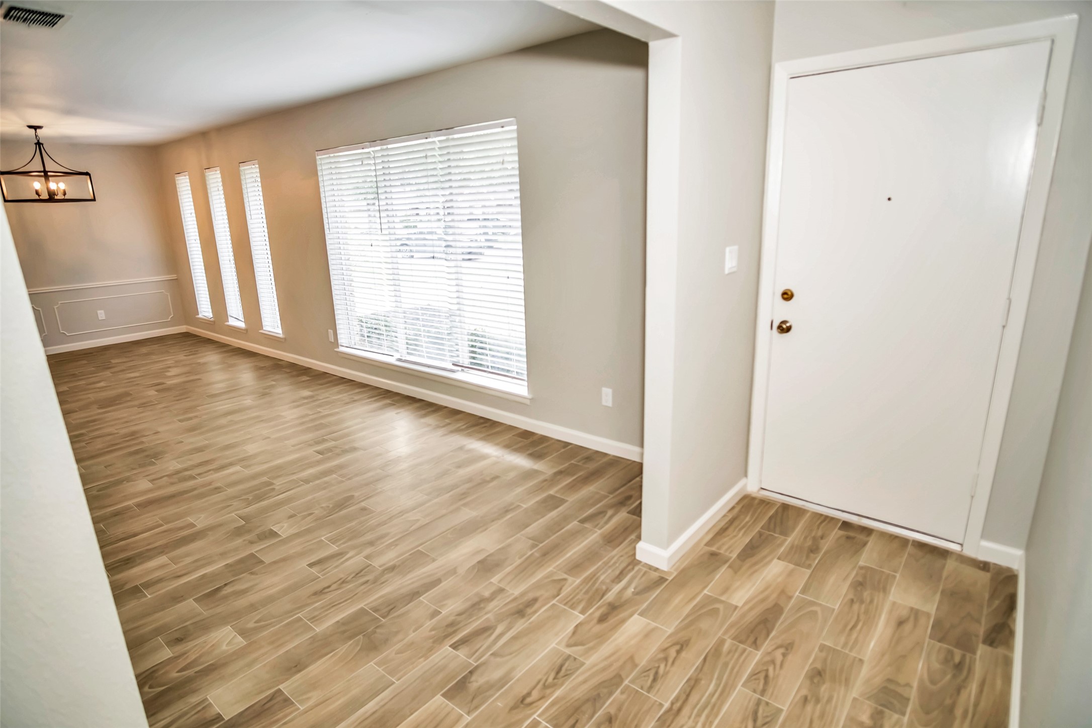 1715 Capstan Road Houston, TX 77062 - Photo 5 of 40 an empty room with wooden floor and windows