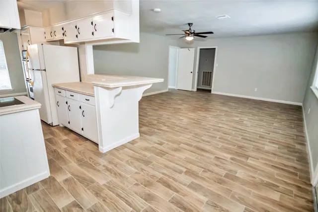 a view of kitchen with wooden floor