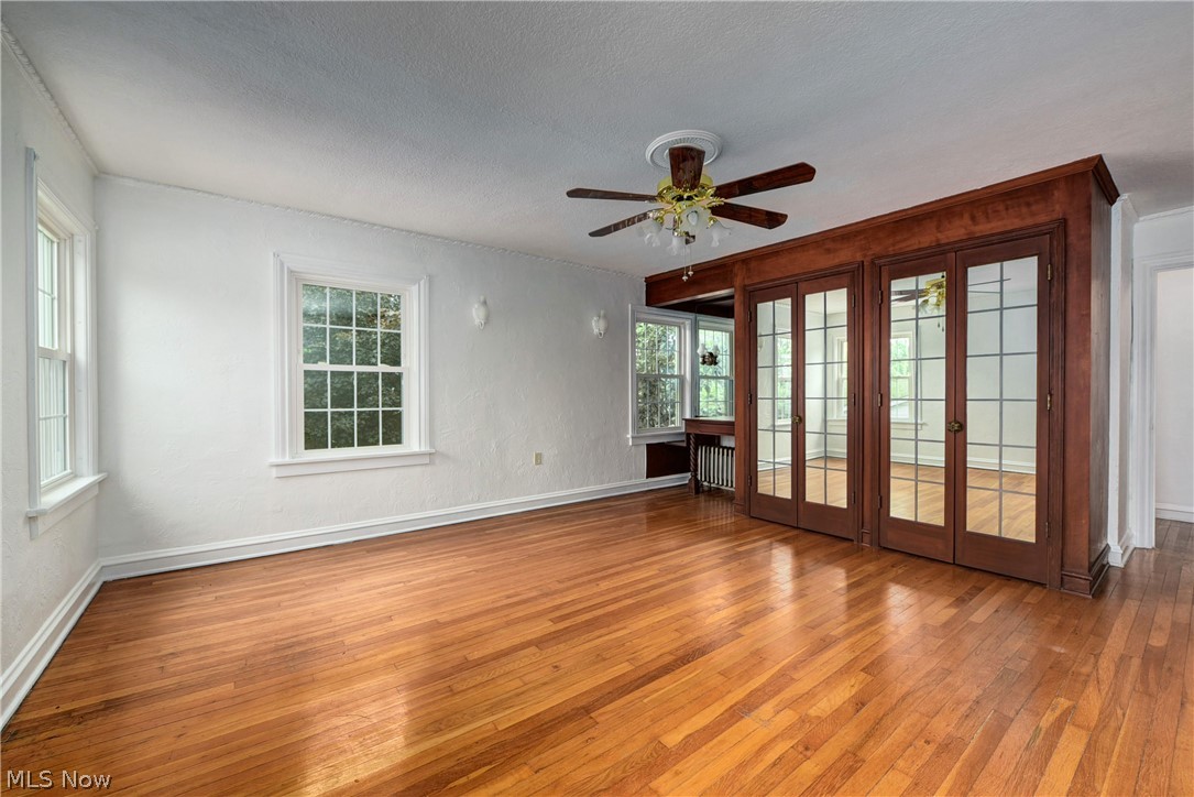 6624 Som Center Road Solon, OH 44139 - Photo 14 of 38 Unfurnished room with plenty of natural light, ceiling fan, french doors, and wood-type flooring