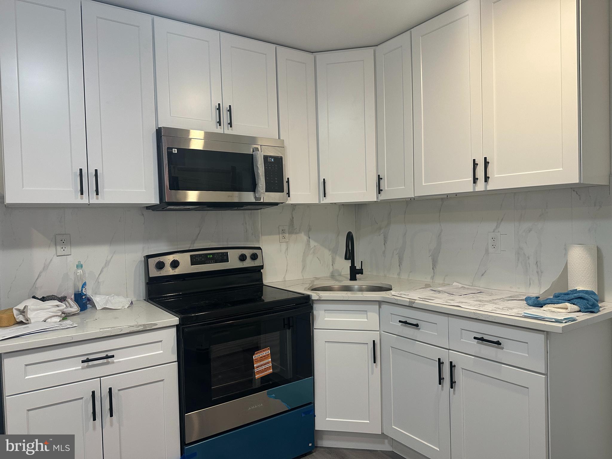 3843 Baring Street Philadelphia, PA 19104 - Photo 16 of 30 a kitchen with granite countertop white cabinets and a stove a oven with white countertops