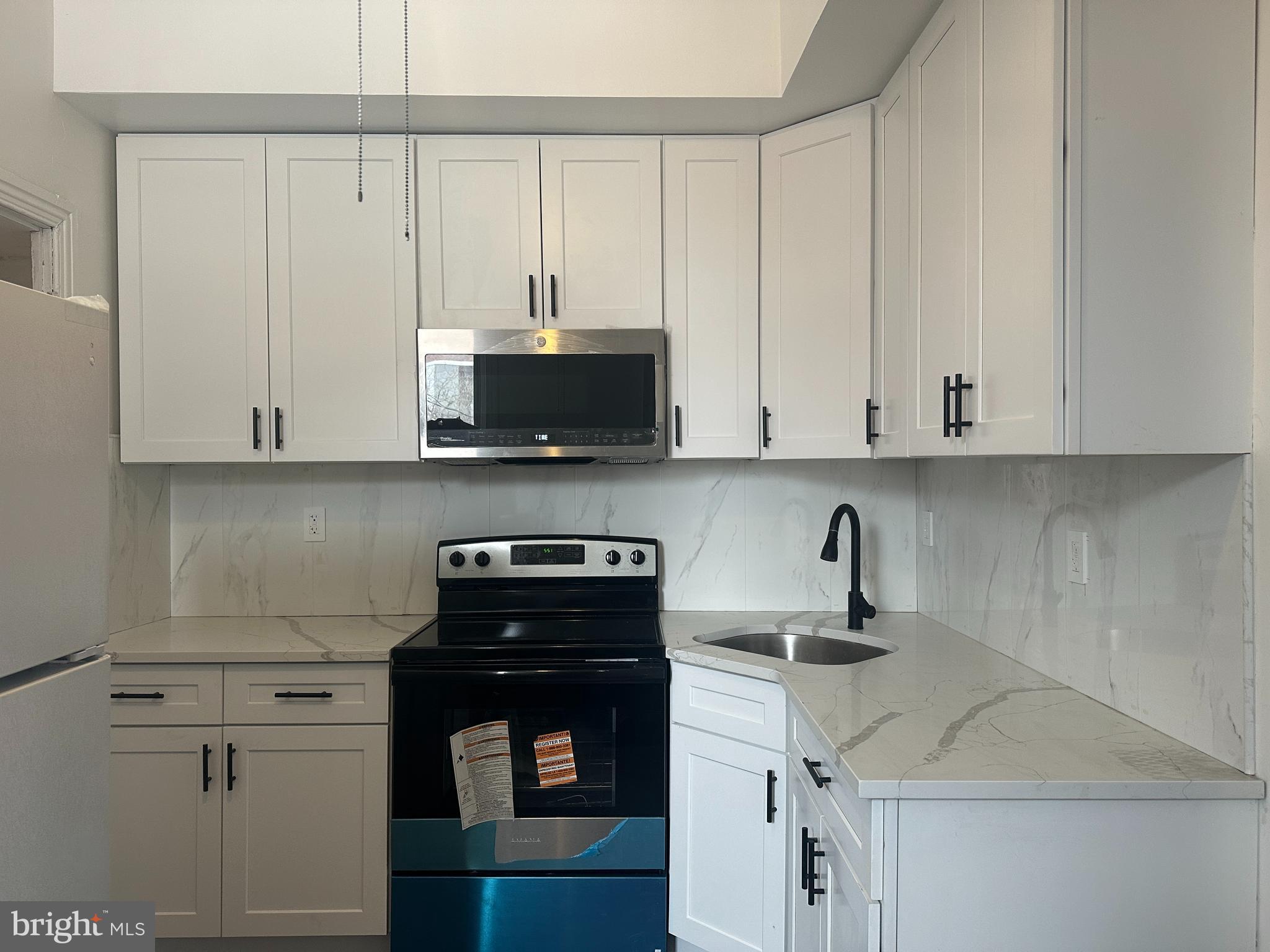 3843 Baring Street Philadelphia, PA 19104 - Photo 18 of 30 a kitchen with stainless steel appliances white cabinets and a sink