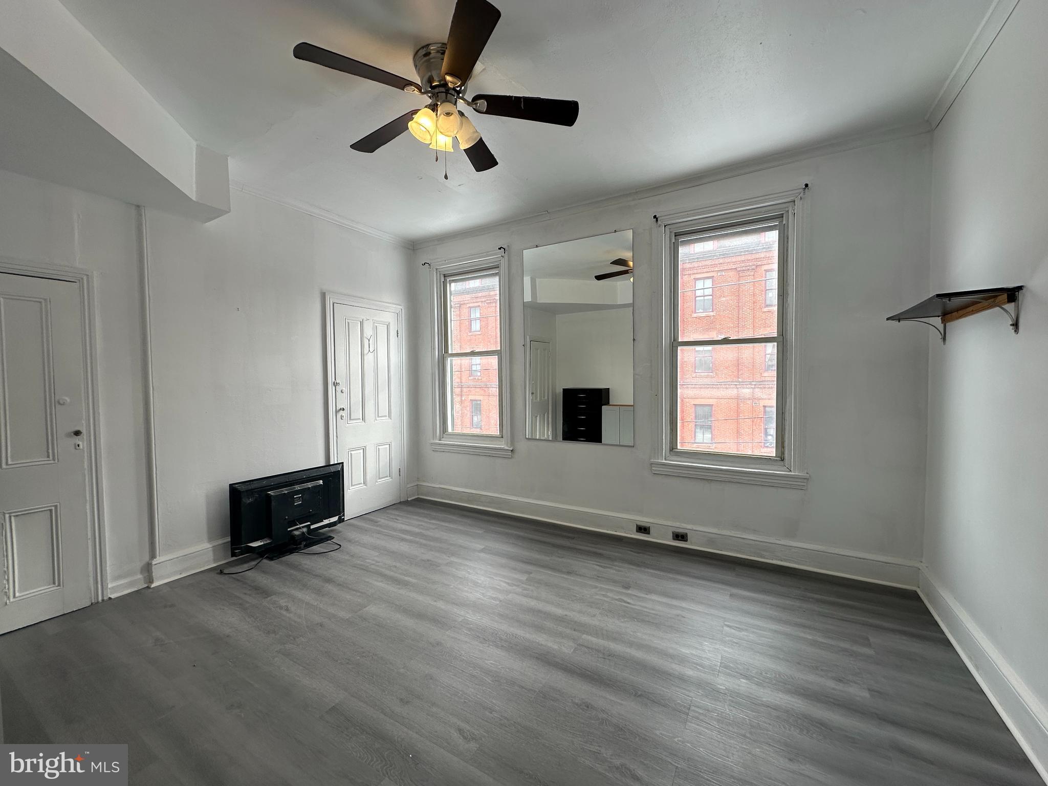 3843 Baring Street Philadelphia, PA 19104 - Photo 21 of 30 an empty room with wooden floor and windows