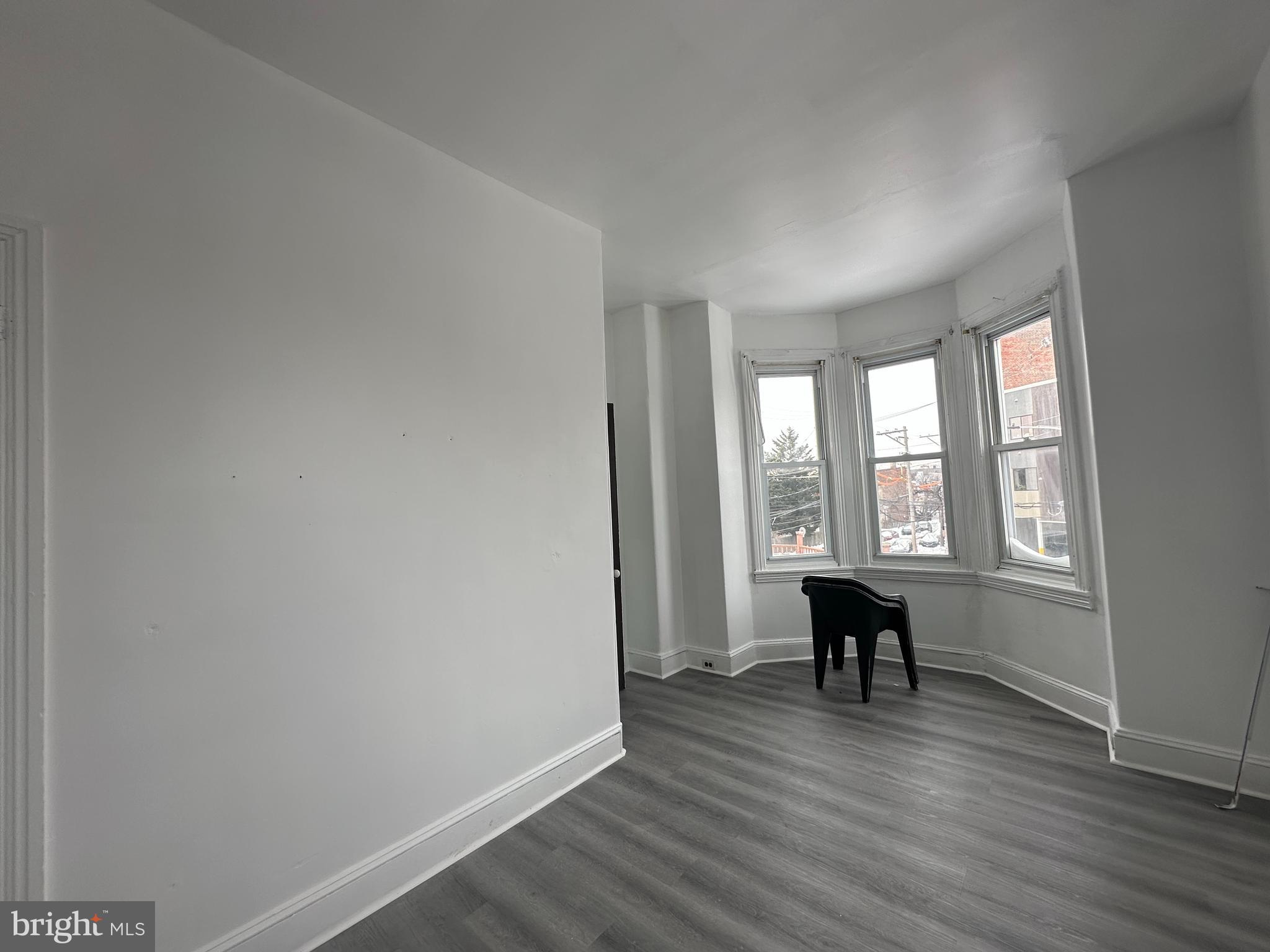 3843 Baring Street Philadelphia, PA 19104 - Photo 24 of 30 an empty room with wooden floor and windows