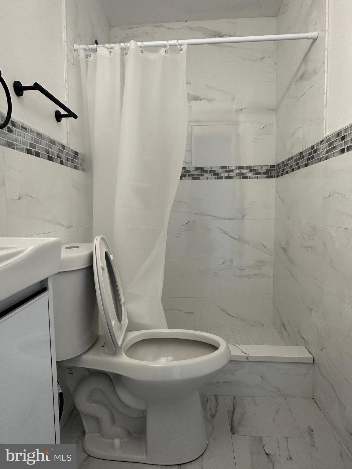 3843 Baring Street Philadelphia, PA 19104 - Photo 27 of 30 a white toilet sitting next to a bath tub