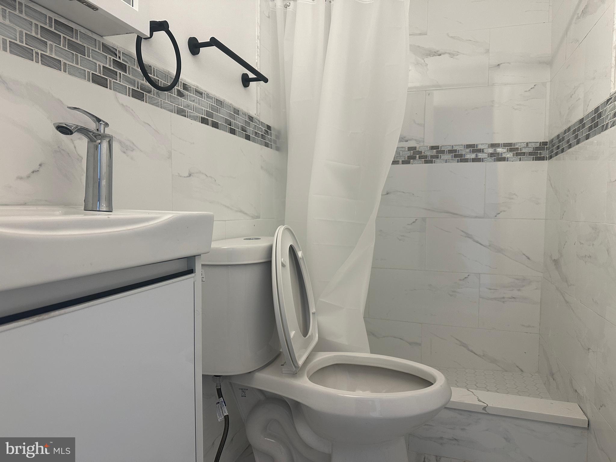 3843 Baring Street Philadelphia, PA 19104 - Photo 29 of 30 a bathroom with a sink a toilet and shower