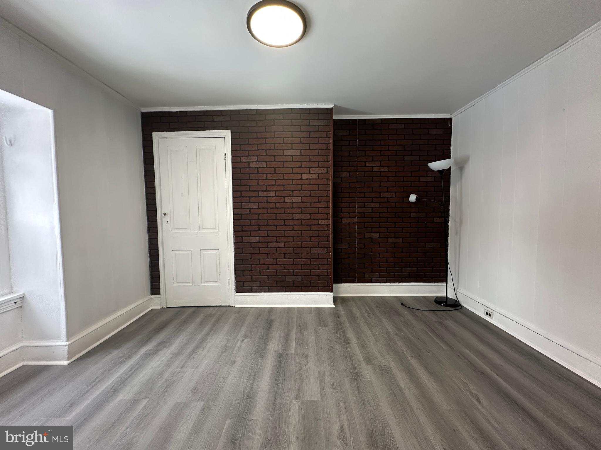 3843 Baring Street Philadelphia, PA 19104 - Photo 30 of 30 an empty room with wooden floor and windows