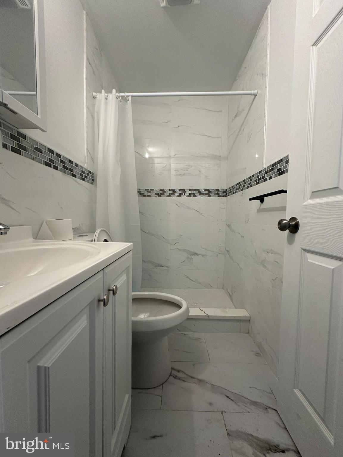 3843 Baring Street Philadelphia, PA 19104 - Photo 3 of 30 a bathroom with a sink toilet and shower