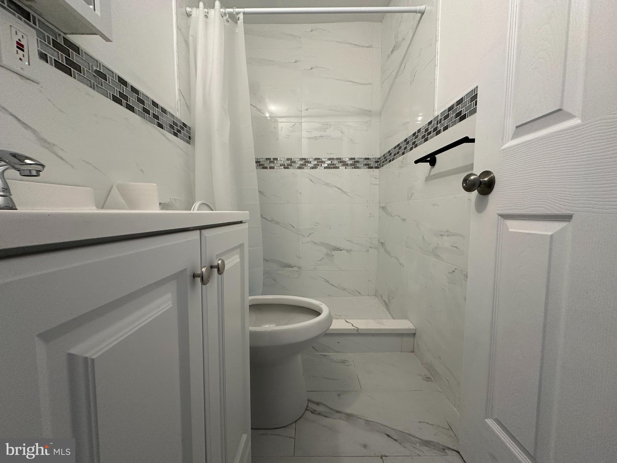 3843 Baring Street Philadelphia, PA 19104 - Photo 4 of 30 a bathroom with a sink a toilet and shower