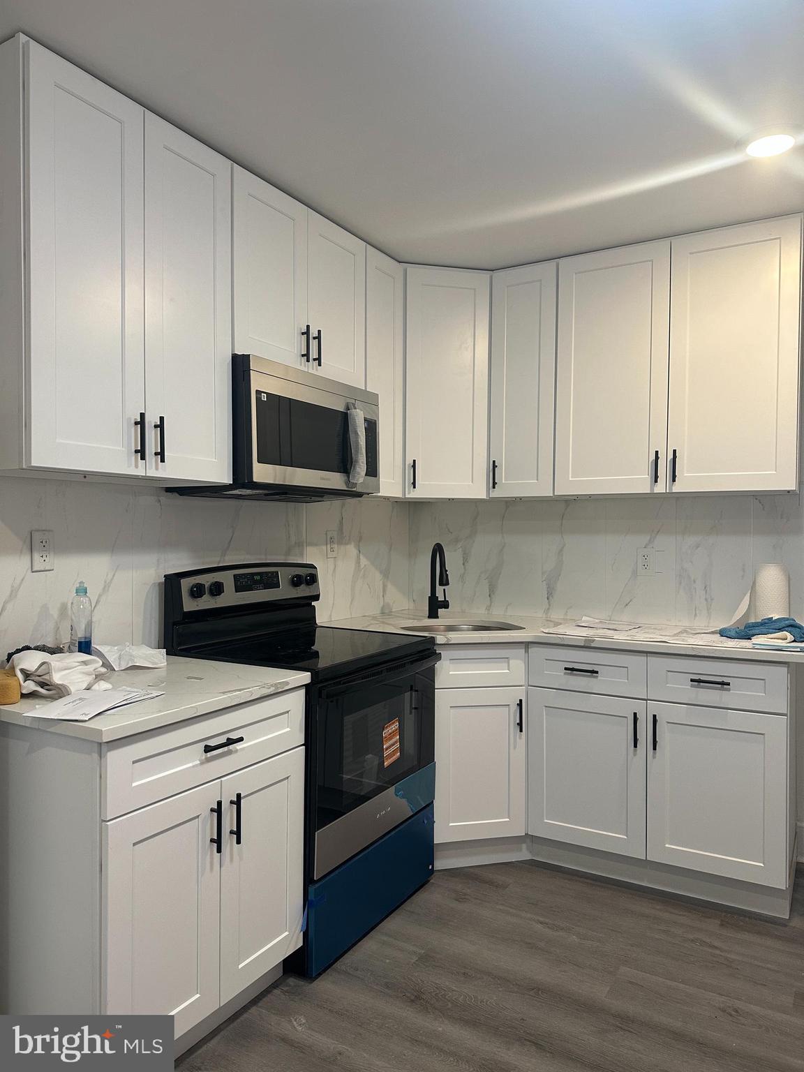 3843 Baring Street Philadelphia, PA 19104 - Photo 7 of 30 a kitchen with stainless steel appliances granite countertop a stove a sink and white cabinets