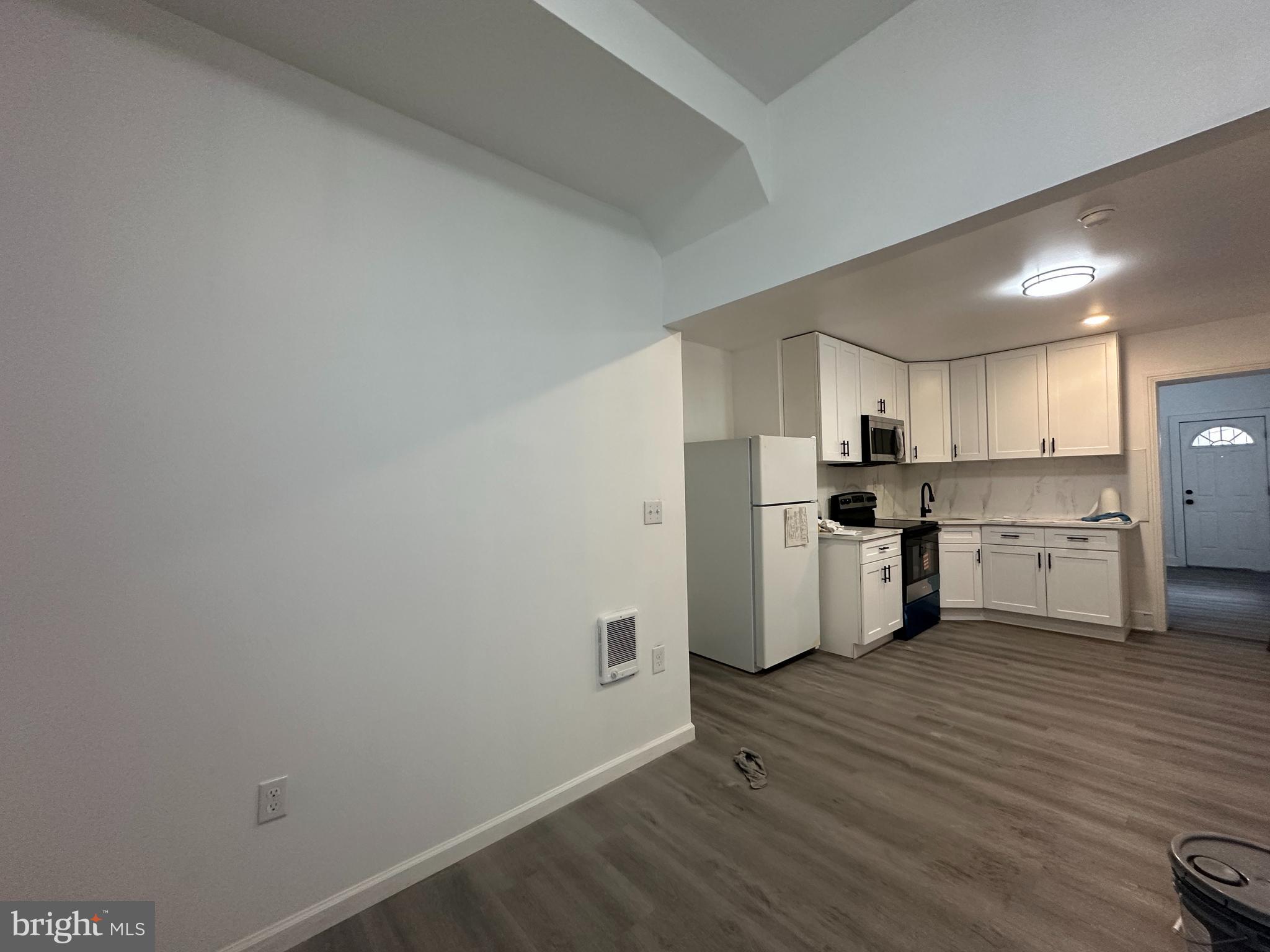3843 Baring Street Philadelphia, PA 19104 - Photo 10 of 30 a kitchen with white cabinets and stainless steel appliances