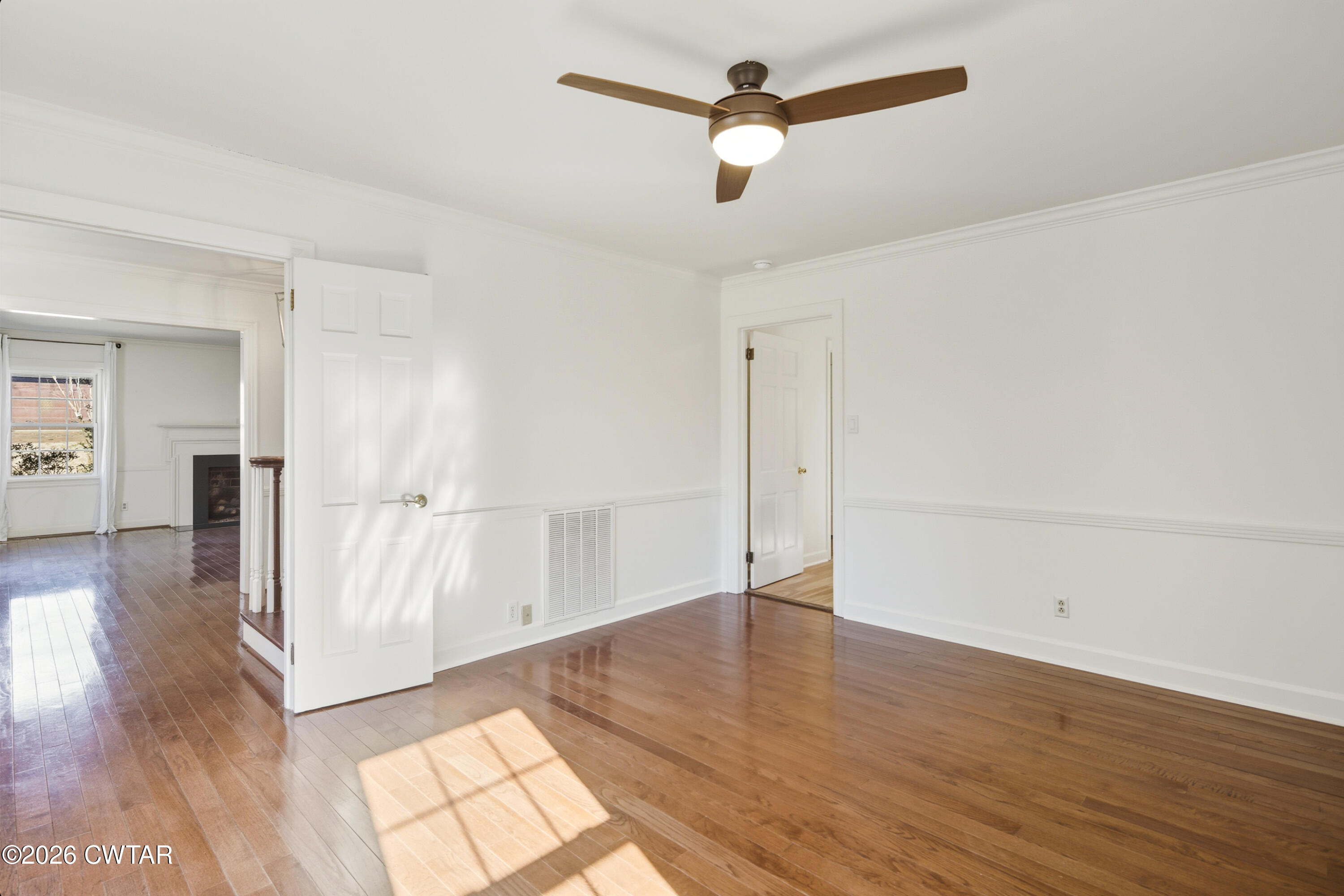 126 Rooks Drive Brownsville, TN 38012 - Photo 15 of 52 a view of empty room with wooden floor and window