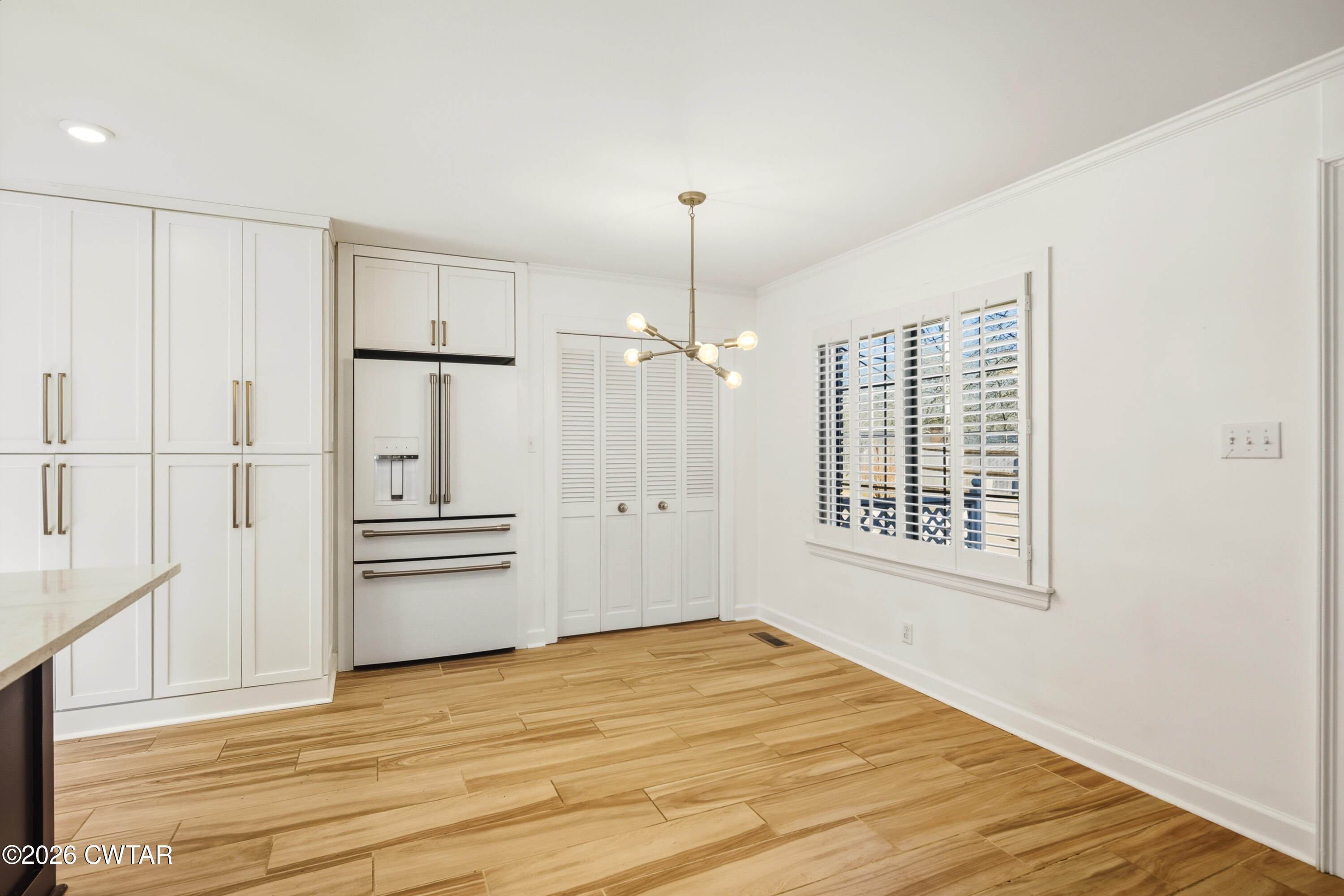 126 Rooks Drive Brownsville, TN 38012 - Photo 20 of 52 an empty room with wooden floor cabinet and windows