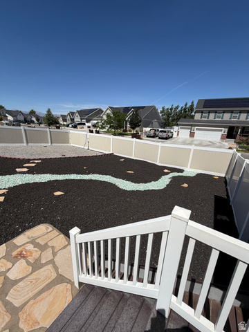 118 Tram Rock Rd. Lake Point, UT 84074 - Photo 30 of 34 Expansive backyard featuring decorative black mulch, light-colored gravel, and a winding light-colored stone path