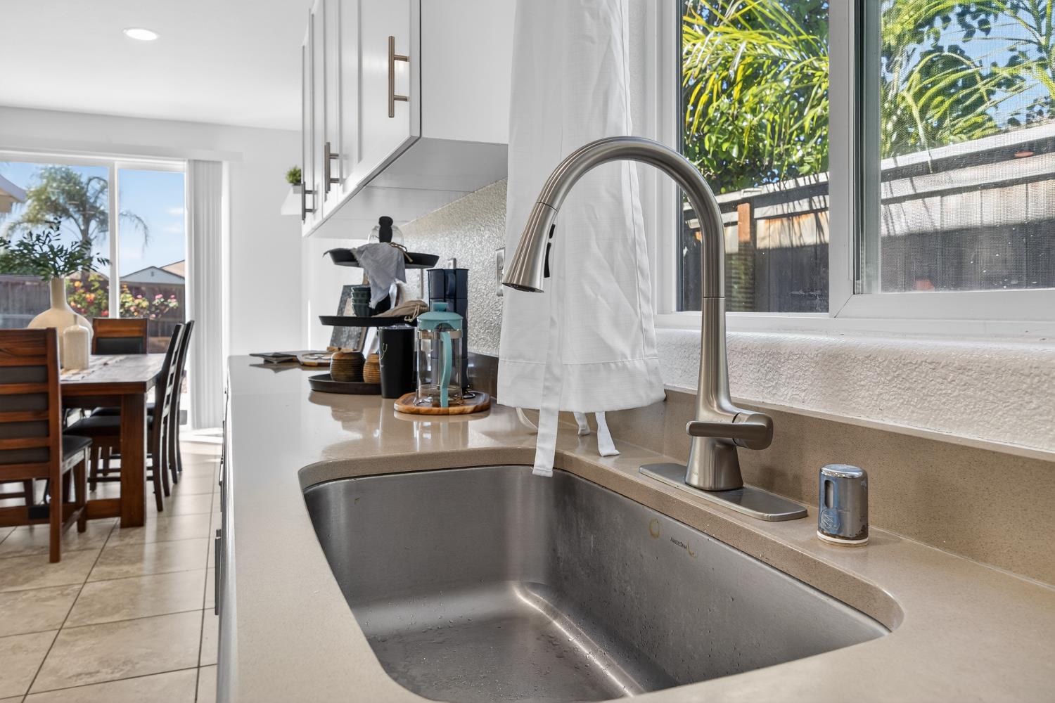 7620 Ferrell Way Elk Grove, CA 95757 - Photo 27 of 75 a kitchen with a faucet a sink and a table with chairs in it