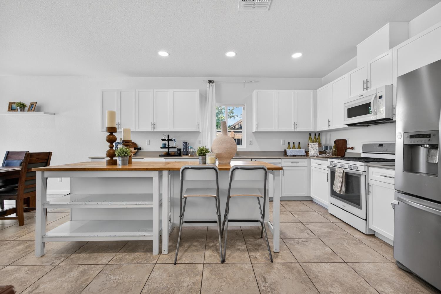 7620 Ferrell Way Elk Grove, CA 95757 - Photo 29 of 75 a kitchen with white cabinets and white appliances