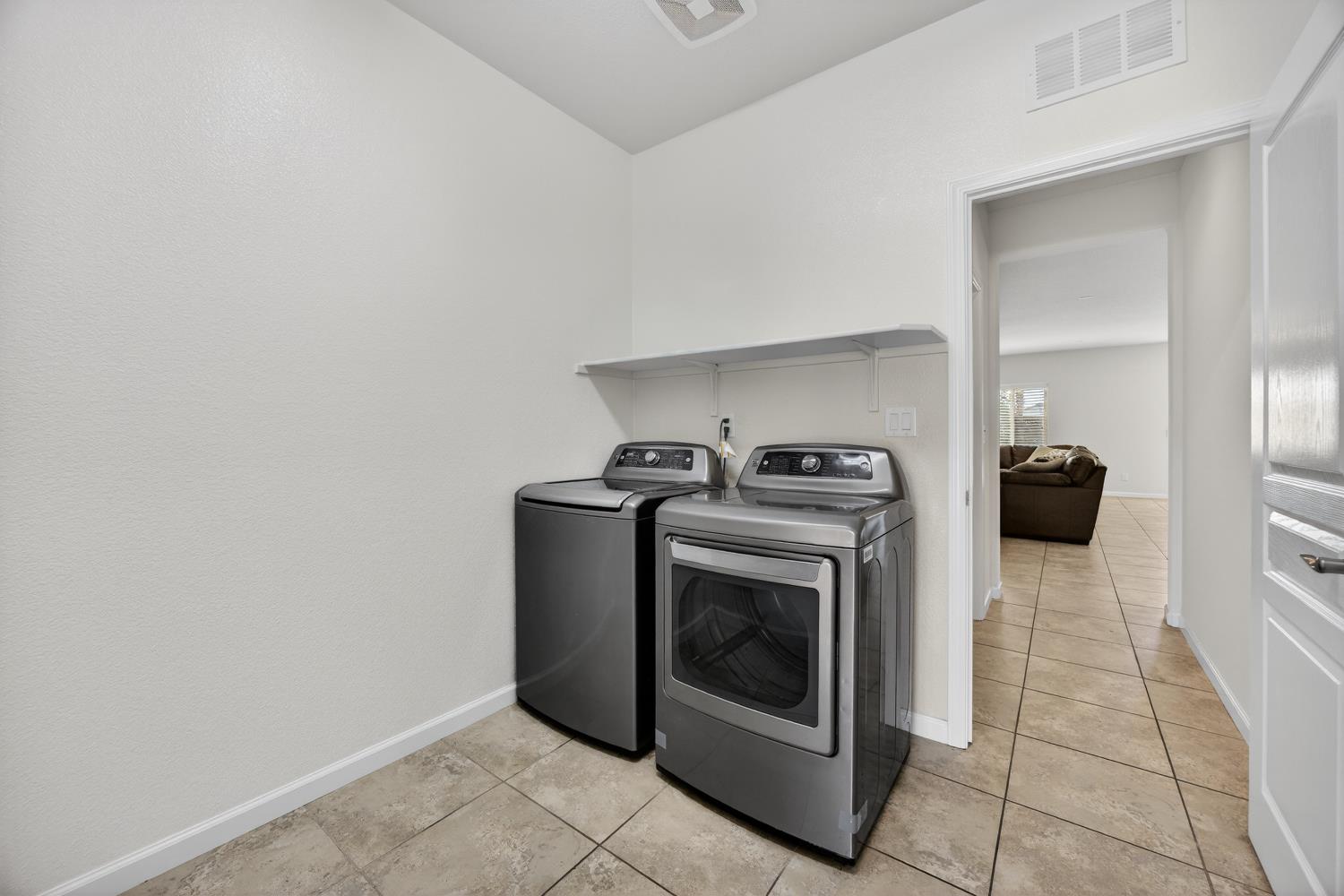7620 Ferrell Way Elk Grove, CA 95757 - Photo 33 of 75 a view of washer and dryer with kitchen in the background