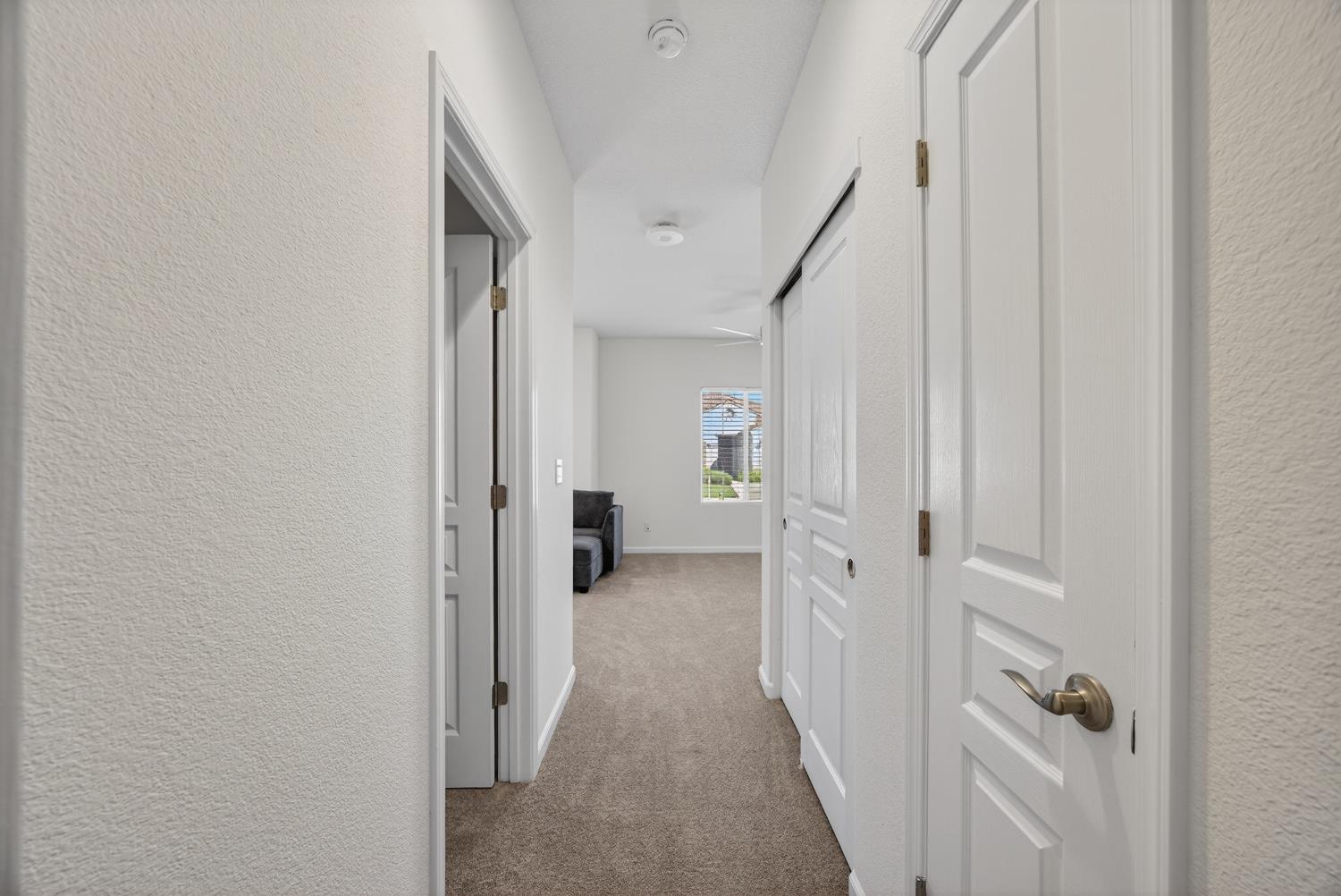 7620 Ferrell Way Elk Grove, CA 95757 - Photo 48 of 75 a view of a hallway with white walls and stairs