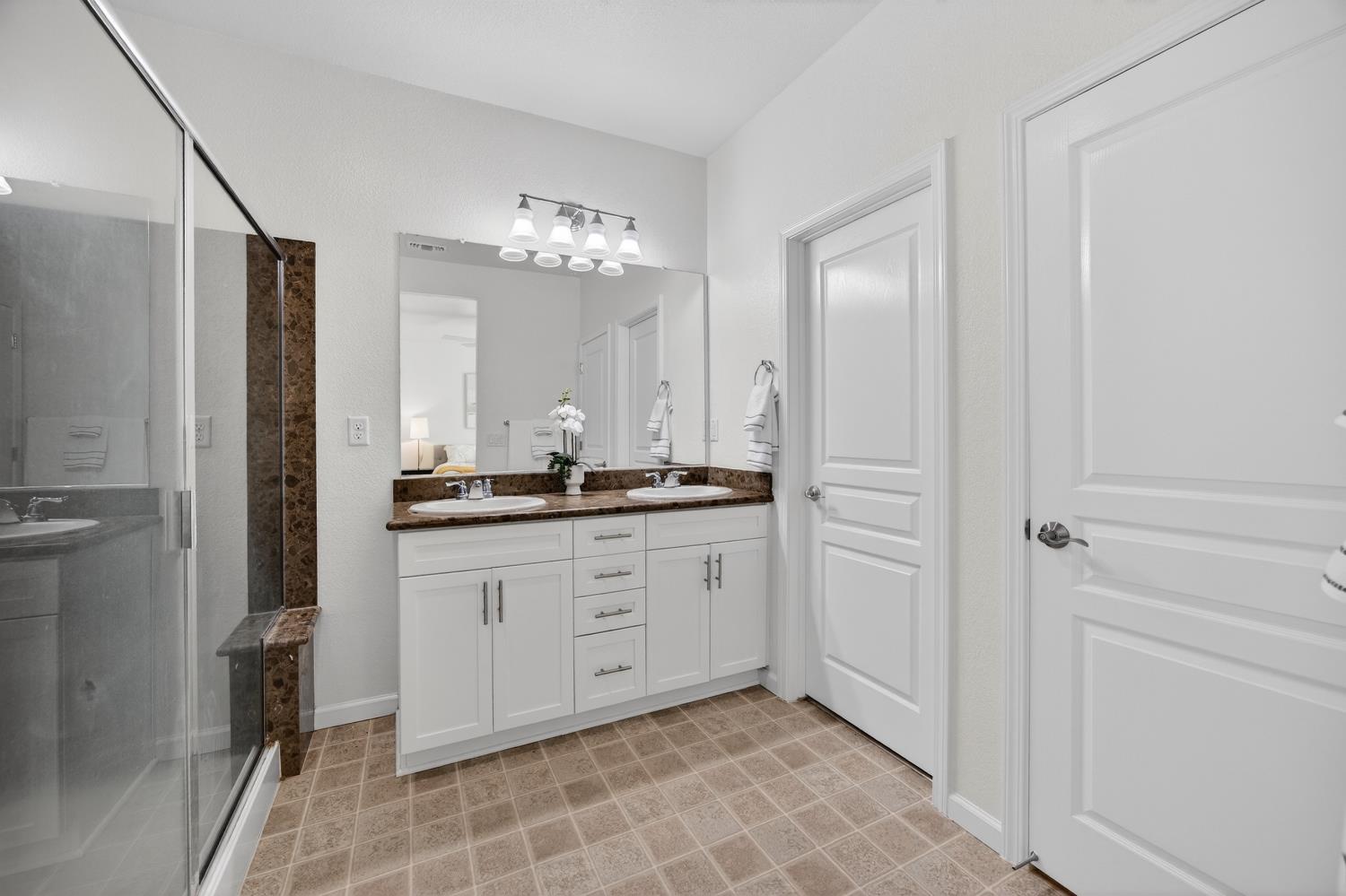 7620 Ferrell Way Elk Grove, CA 95757 - Photo 6 of 75 a spacious bathroom with a mirror and a shower