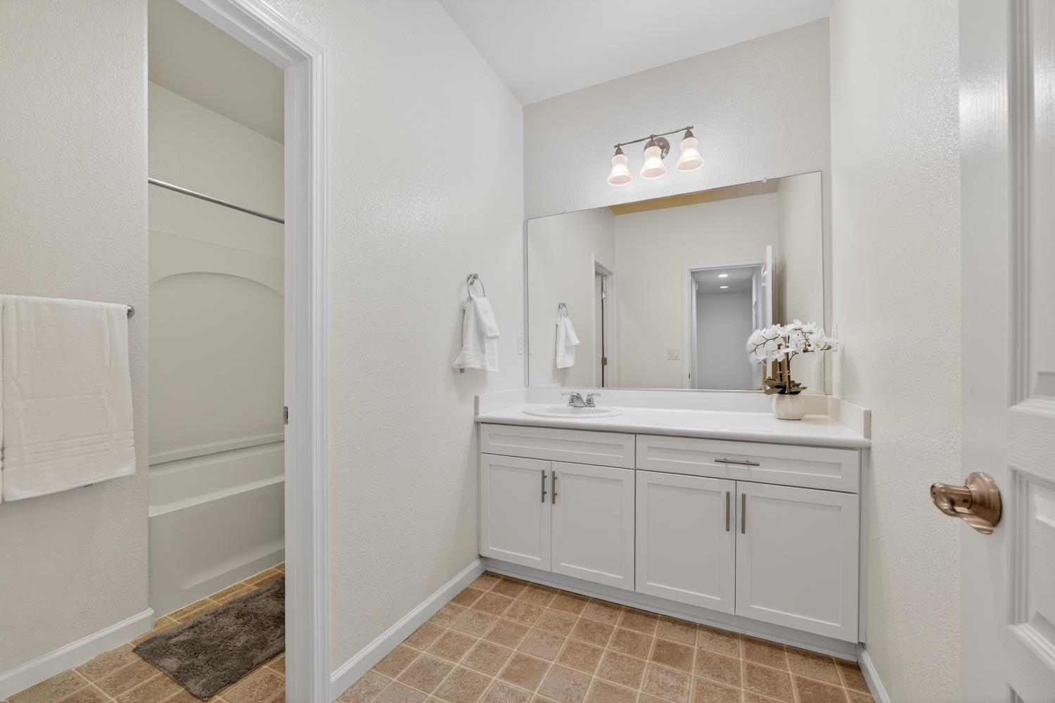 7620 Ferrell Way Elk Grove, CA 95757 - Photo 10 of 75 a bathroom with a double vanity sink and a mirror