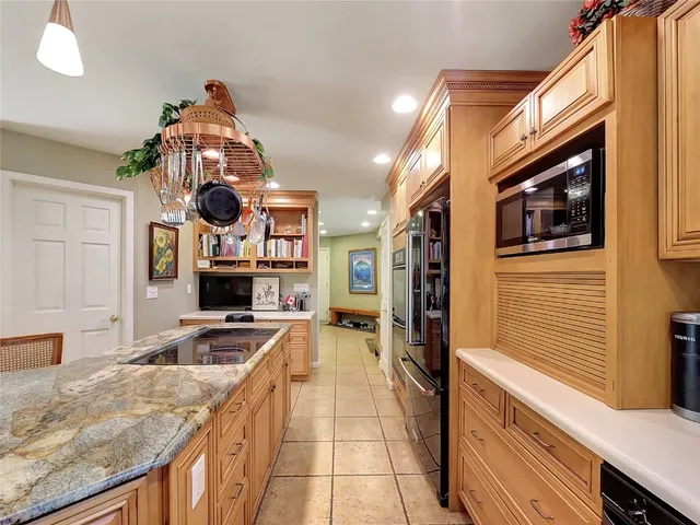 a kitchen with a stove a refrigerator and a sink